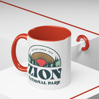 11 oz ceramic mug with red contrasting handle featuring an established 1919 design of Zion National Park, perfect as a souvenir.