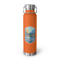 Orange stainless steel water bottle featuring a design of Voyageurs National Park with a lake and forest scenery.