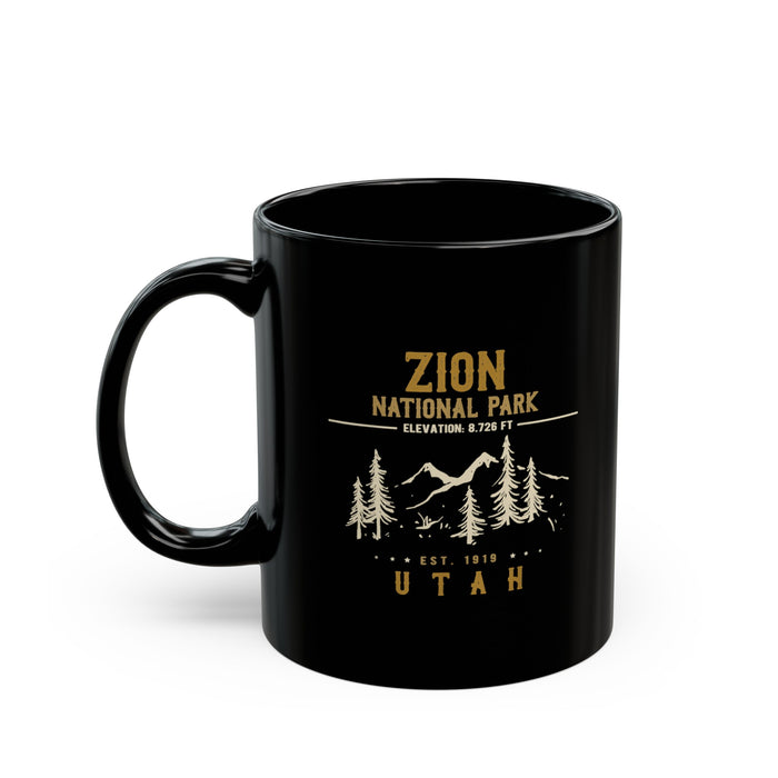 Black ceramic mug featuring a design of Zion National Park with mountains, trees, and elevation details.