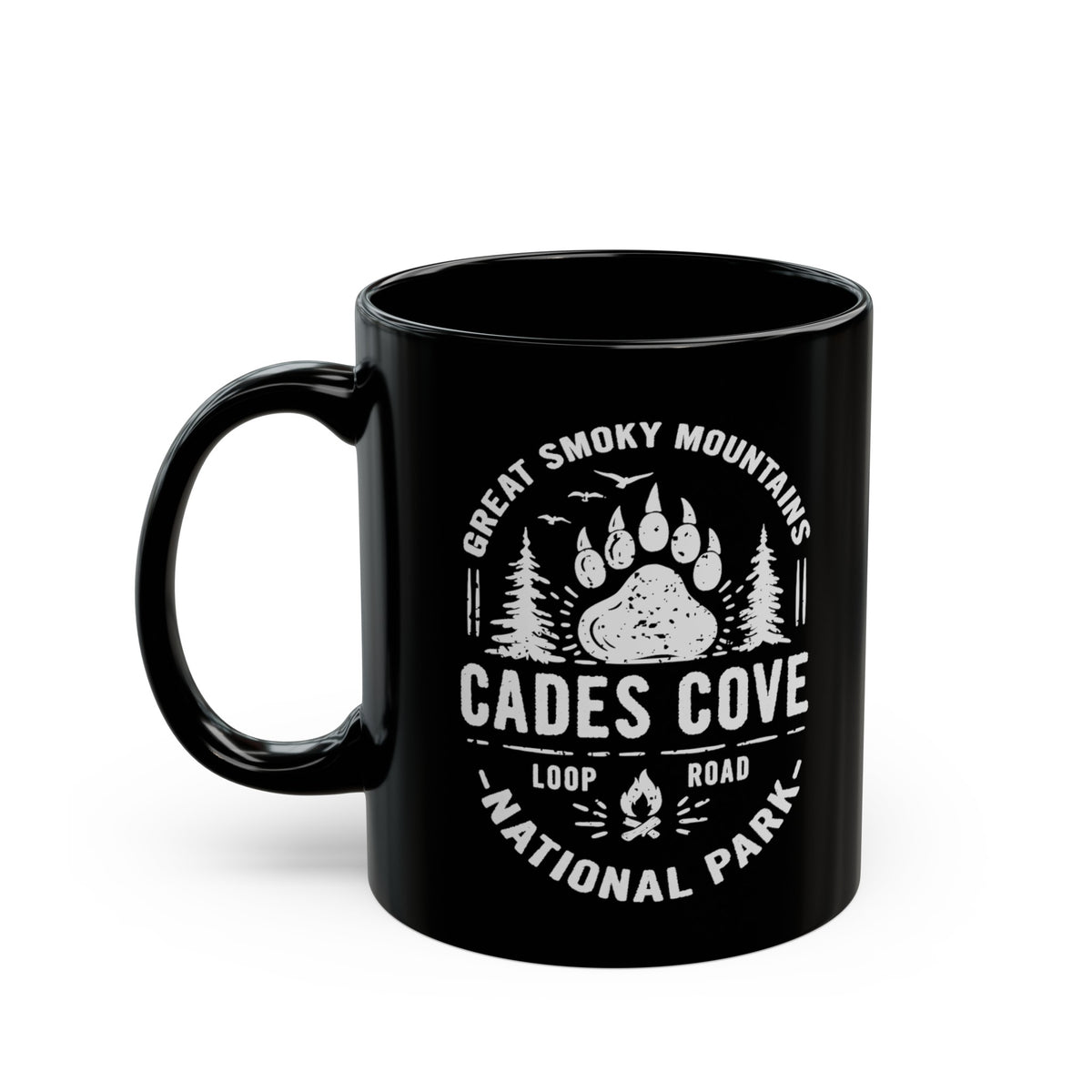 Ceramic mug featuring a design with a bear paw print and trees, representing Great Smoky Mountains National Park and Cades Cove Loop Road.