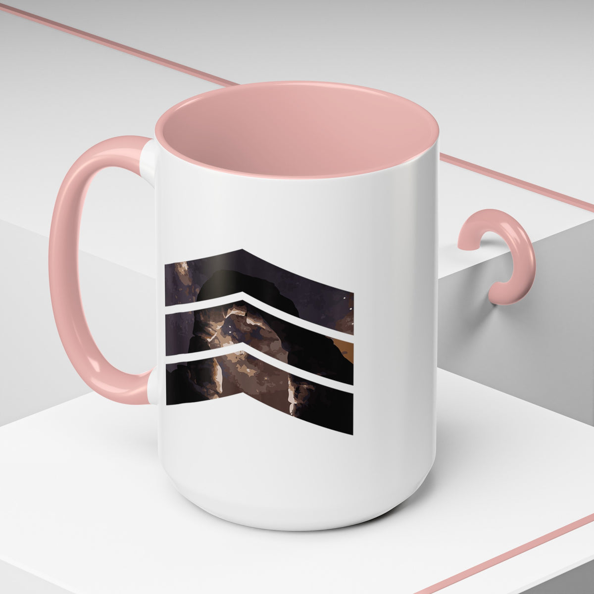 15 oz ceramic mug with pink handle featuring a mountain design with three chevrons, representing Arches National Park.