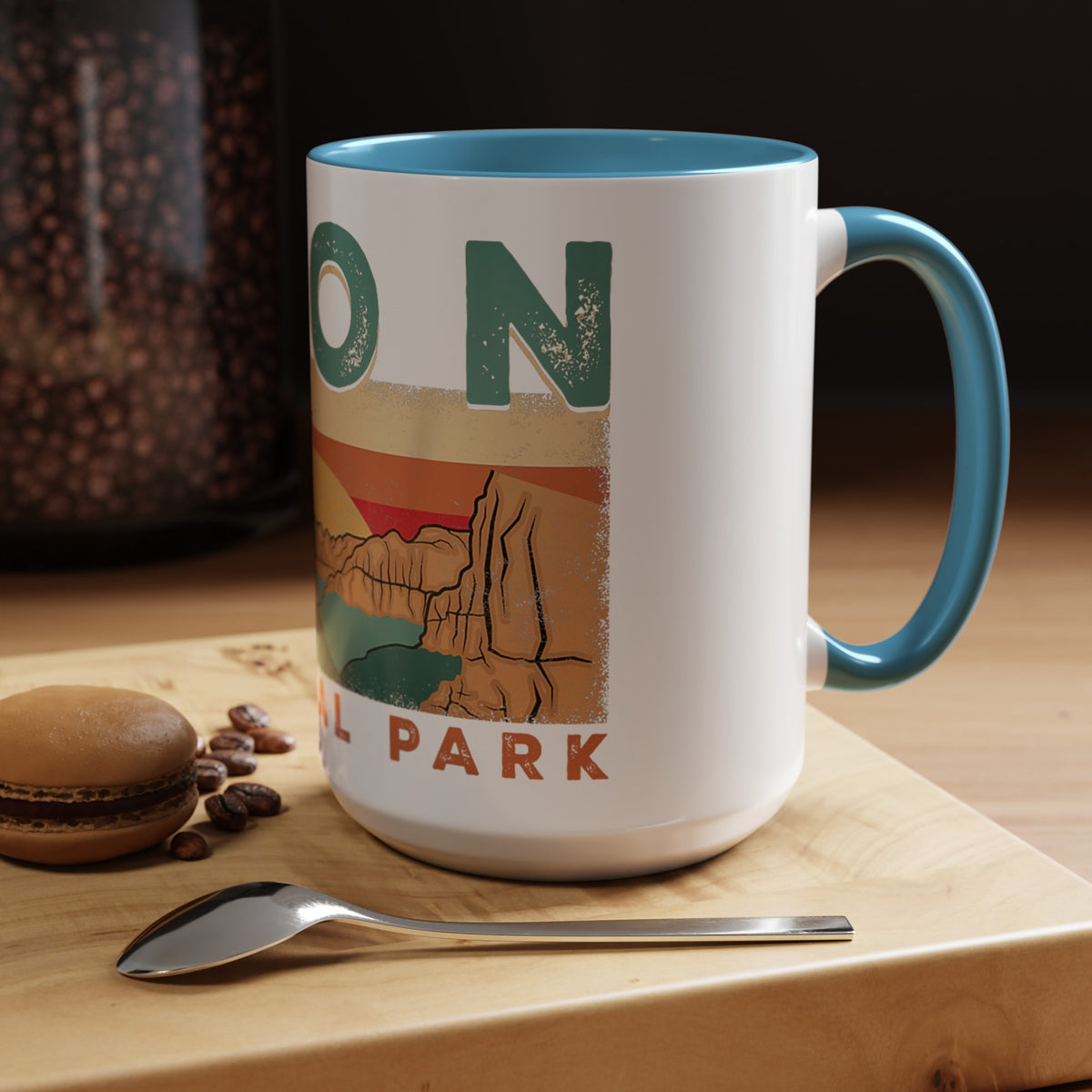 White ceramic mug with contrasting handle and interior, featuring a sunset landscape design of Zion National Park.