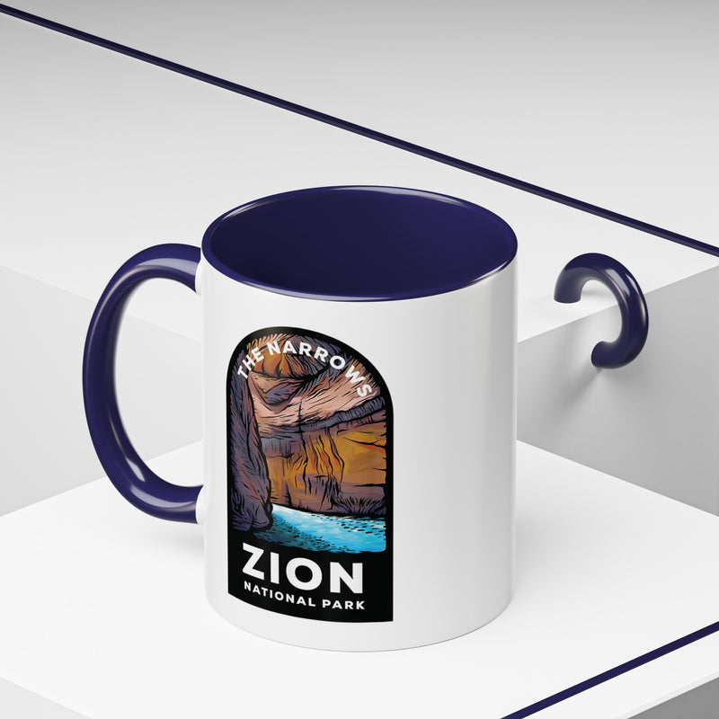 11 oz ceramic mug with navy contrasting handle featuring a design of The Narrows at Zion National Park, perfect as a souvenir.