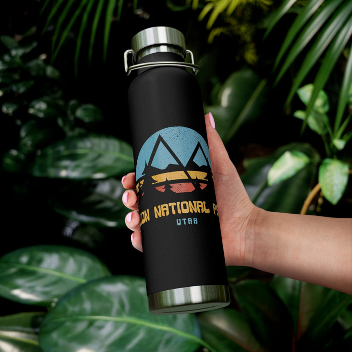 Image of a stainless steel water bottle featuring a sunset design from Zion National Park in Utah.