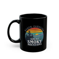 Ceramic mug featuring an illustration of Great Smoky Mountains National Park with a sunset, trees, and North Carolina text.