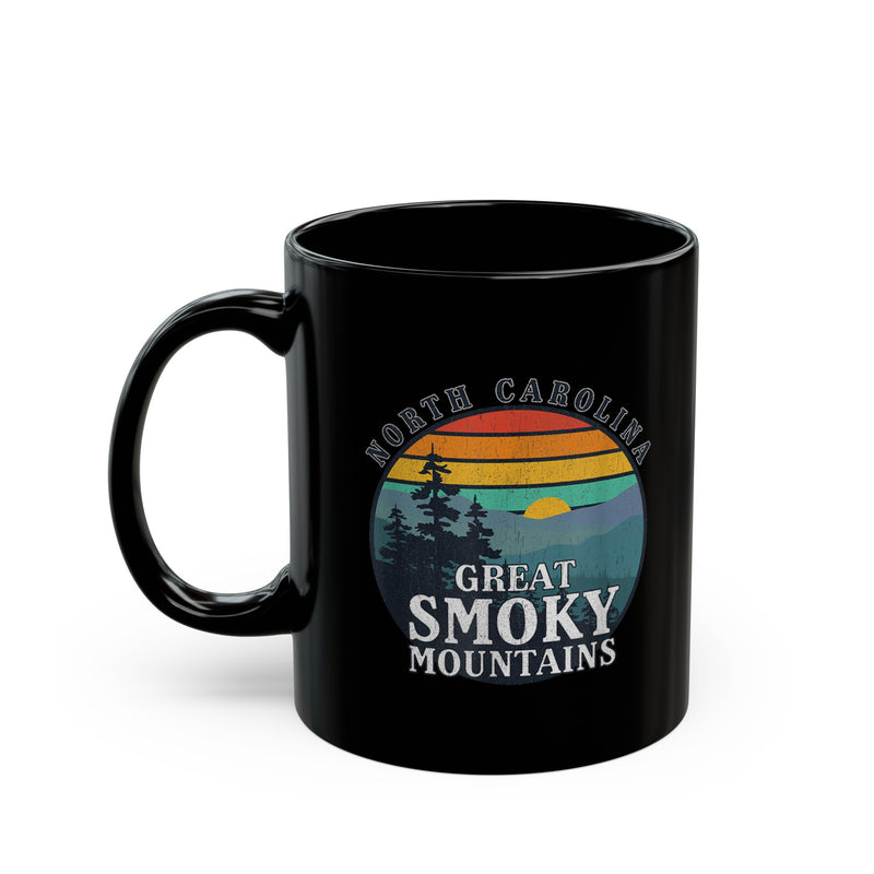 Ceramic mug featuring an illustration of Great Smoky Mountains National Park with a sunset, trees, and North Carolina text.