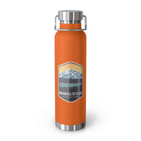 Orange stainless steel water bottle featuring a design of Wrangell-St. Elias National Park with mountain and sunset scenery.