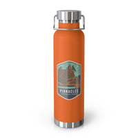 Orange stainless steel water bottle featuring a design of Pinnacles National Park with rock formationss