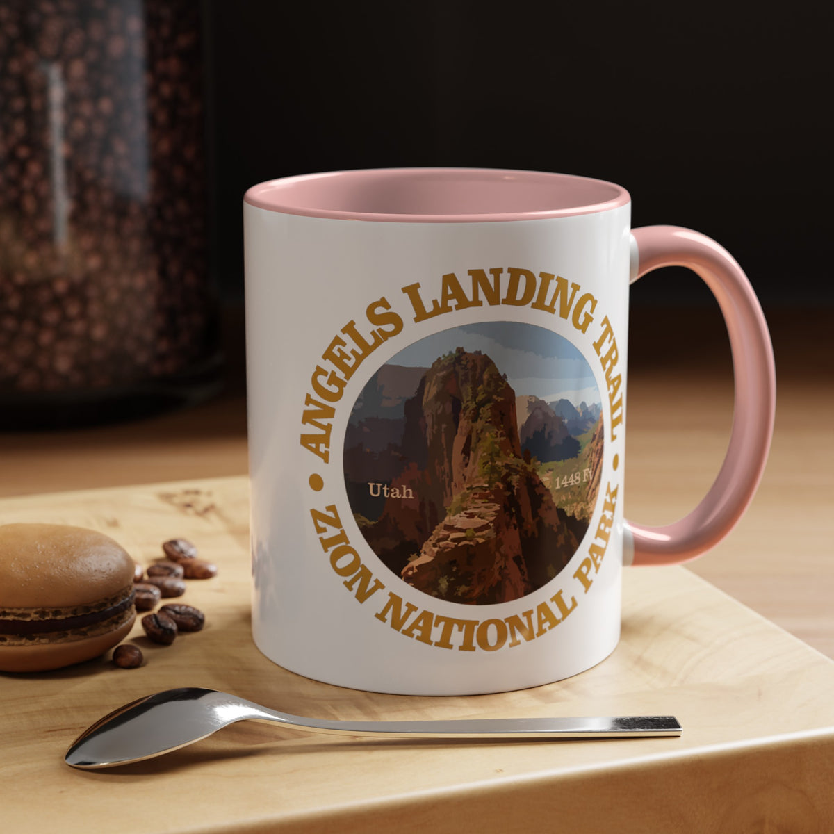 White ceramic mug with a contrasting handle and interior, featuring an image of Angels Landing Trail in Zion National Park with a mountain landscape design.