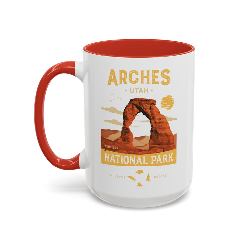 White 15 oz ceramic coffee mug with a red handle, featuring a detailed design of Arches National Park, Utah. Perfect for coffee or tea lovers.