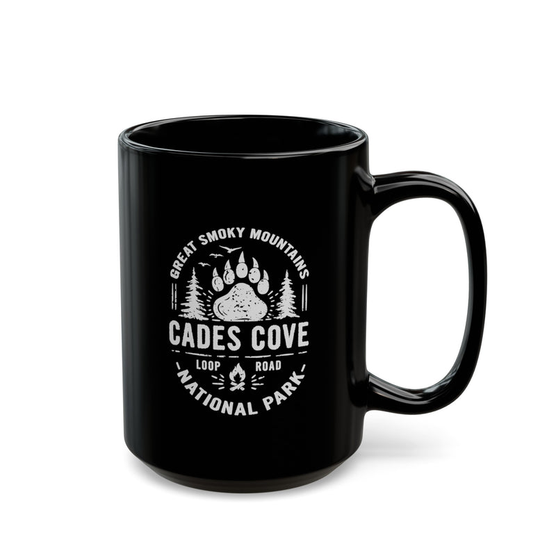 Ceramic mug featuring a design with a bear paw print and trees, representing Great Smoky Mountains National Park and Cades Cove Loop Road.