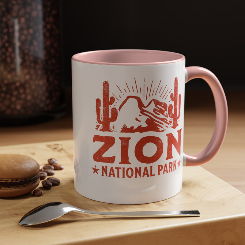 11 oz ceramic mug with pink contrasting handle featuring a cactus design of Zion National Park, perfect as a souvenir.