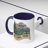 11 oz navy ceramic mug featuring an illustration of Great Smoky Mountains National Park with a scenic view and trees, labeled Tennessee.