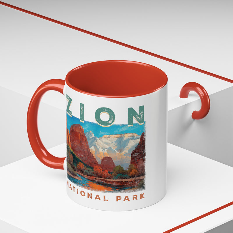 White ceramic mug with a contrasting handle and interior, featuring a scenic landscape design of Zion National Park.