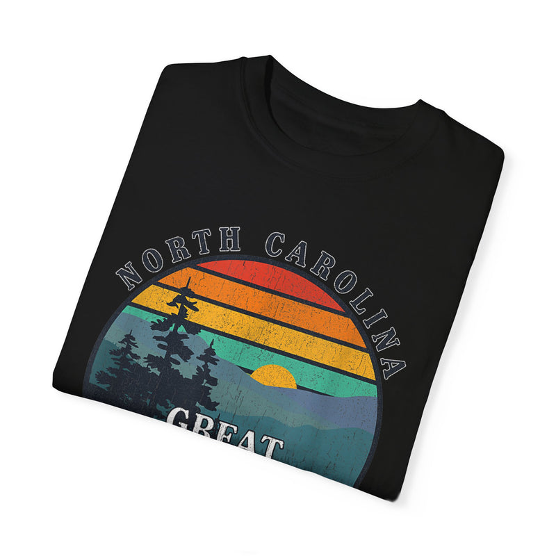 T-shirt featuring a sunset graphic with trees and text "North Carolina Great Smoky Mountains."