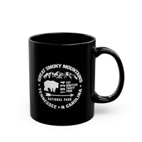 Ceramic mug featuring an illustration of Great Smoky Mountains National Park with a bear and mountains, including Tennessee and North Carolina locations.