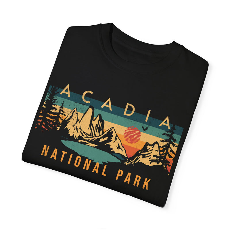 Acadia National Park T-shirt featuring a graphic design with mountains, a sun, and trees.