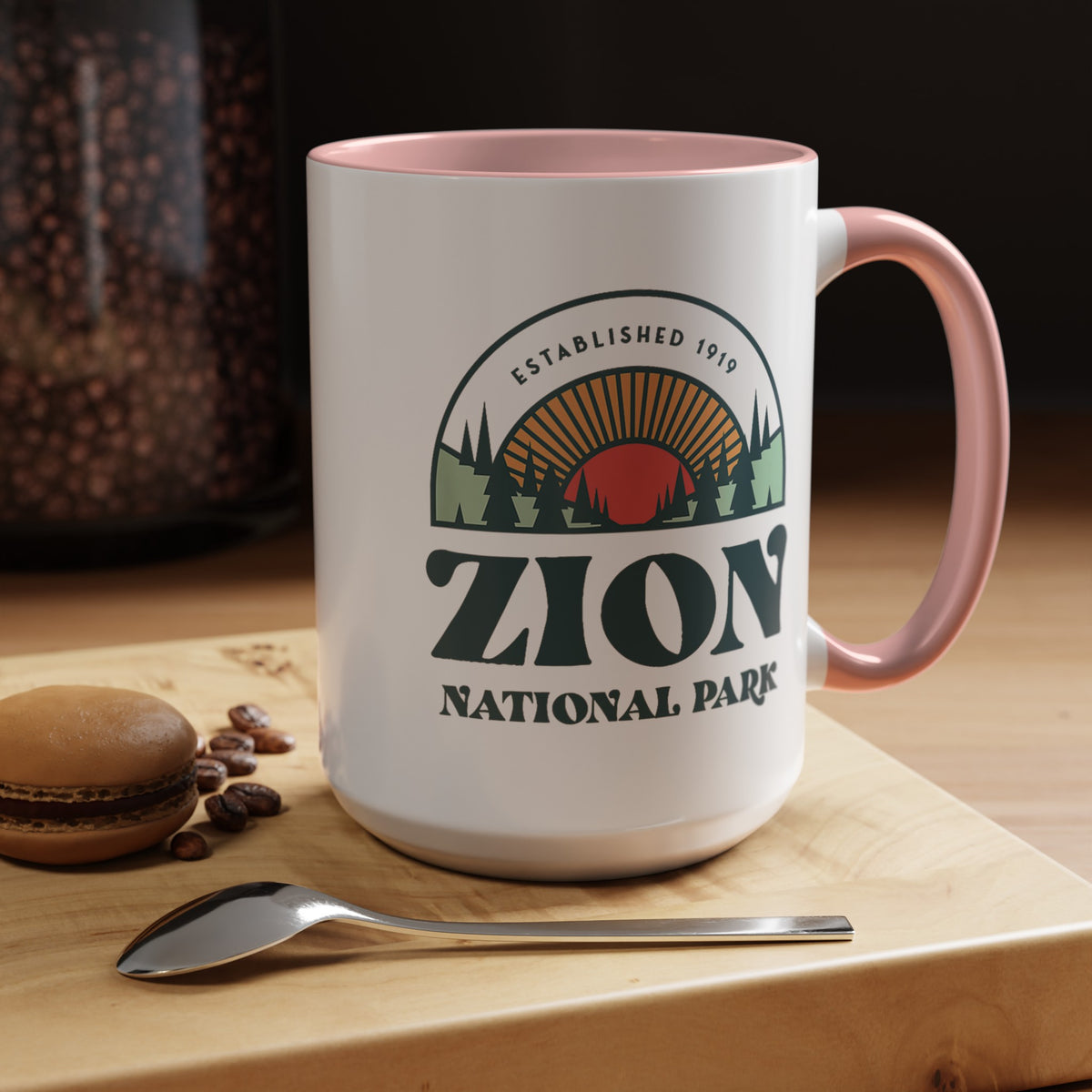 15 oz ceramic mug with pink contrasting handle featuring an established 1919 design of Zion National Park, perfect as a souvenir.