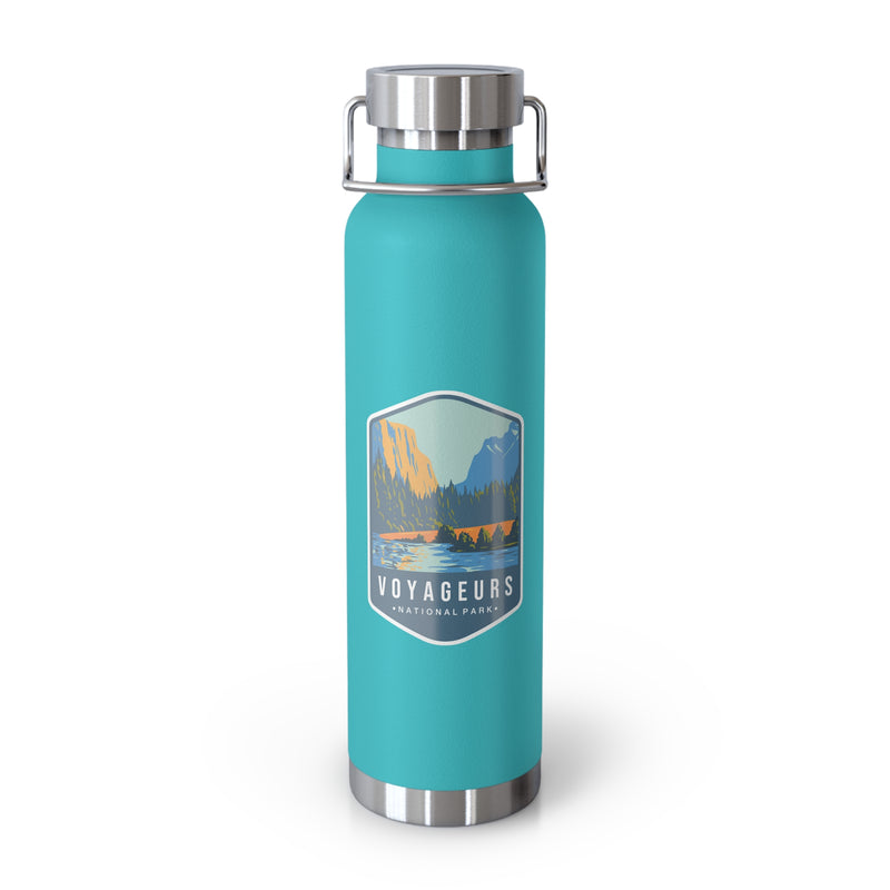 Green Mint stainless steel water bottle featuring a design of Voyageurs National Park with a lake and forest scenery.