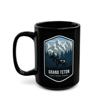 Ceramic mug featuring an illustration of Grand Teton National Park with mountains, trees, and a moose.