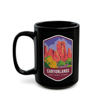 Ceramic mug featuring a scenic design with red rock formations and greenery, representing Canyonlands National Park.