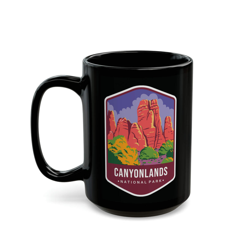 Ceramic mug featuring a scenic design with red rock formations and greenery, representing Canyonlands National Park.