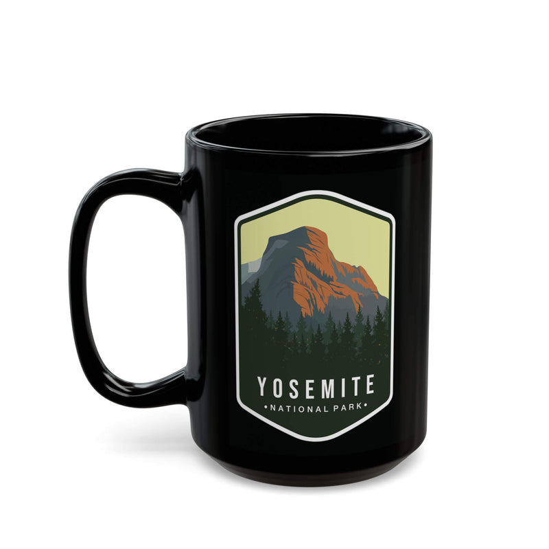 Black ceramic mug featuring a design of Yosemite National Park with a mountain and forest.