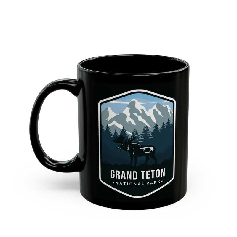 Ceramic mug featuring an illustration of Grand Teton National Park with mountains, trees, and a moose.