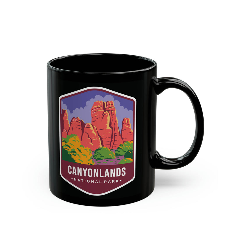 Ceramic mug featuring a scenic design with red rock formations and greenery, representing Canyonlands National Park.